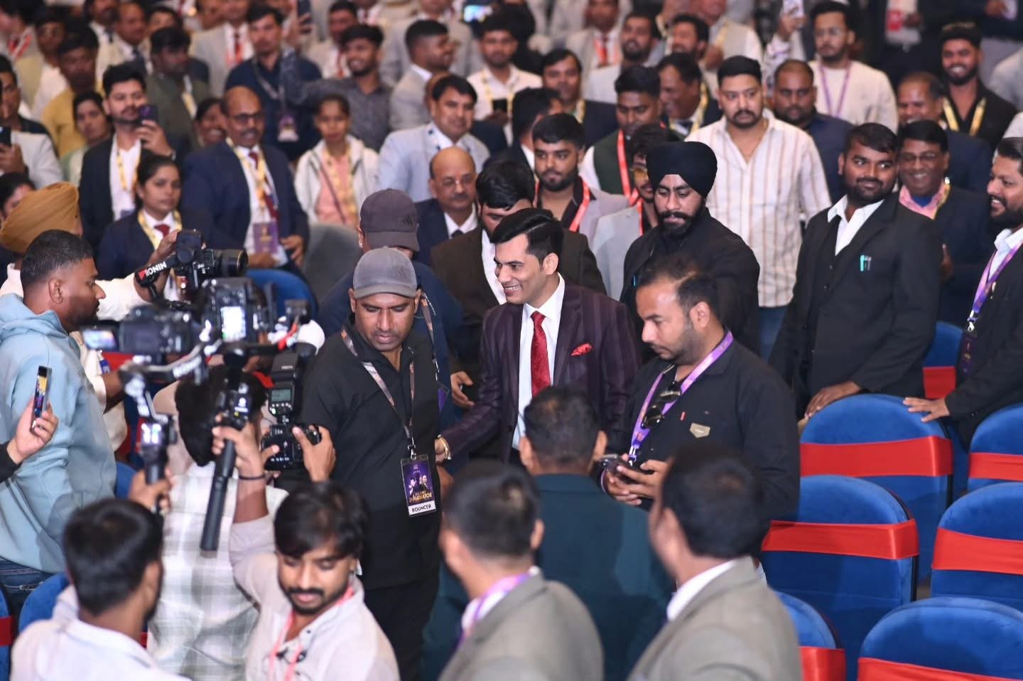 Attendees and media gathering at the summit